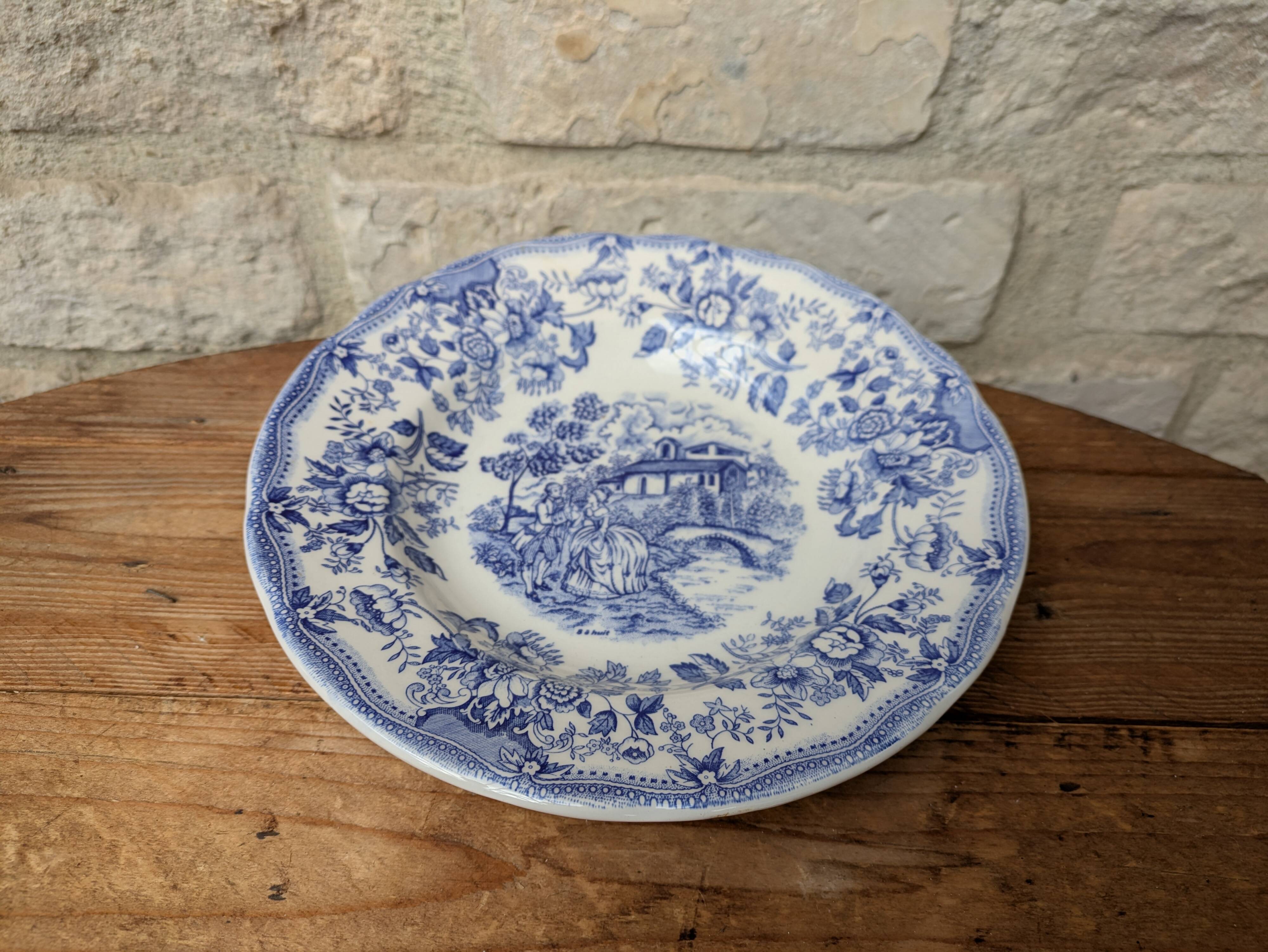 Old deep plate with blue floral pattern and gallant scene
