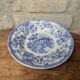 Old deep plate with blue floral pattern and gallant scene