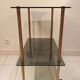 Vintage rolling dessert trolley with smoked glass trays and a golden base.
