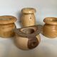 Four solid turned wooden vases
