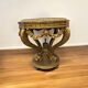 A round Louis XV style table in carved gilt beechwood with a black marble top