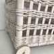 Wicker laundry basket on vintage wooden wheels