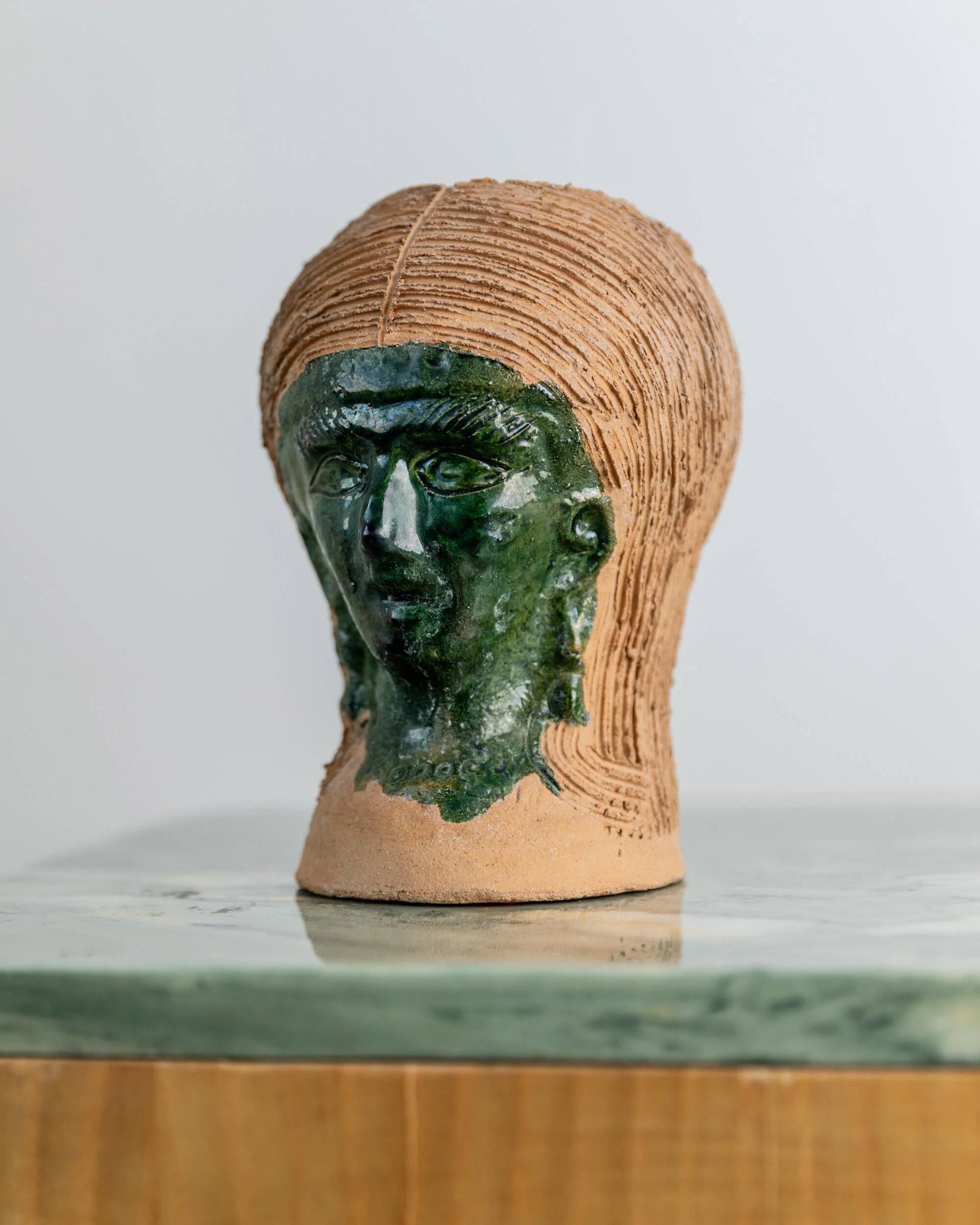 Vintage ceramic vase from the 1980s, sculptural head shape with a green glazed face, terracotta art object.