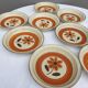 Set 11 plates 1970 Revernay Sarreguemines orange and brown on sandstone background