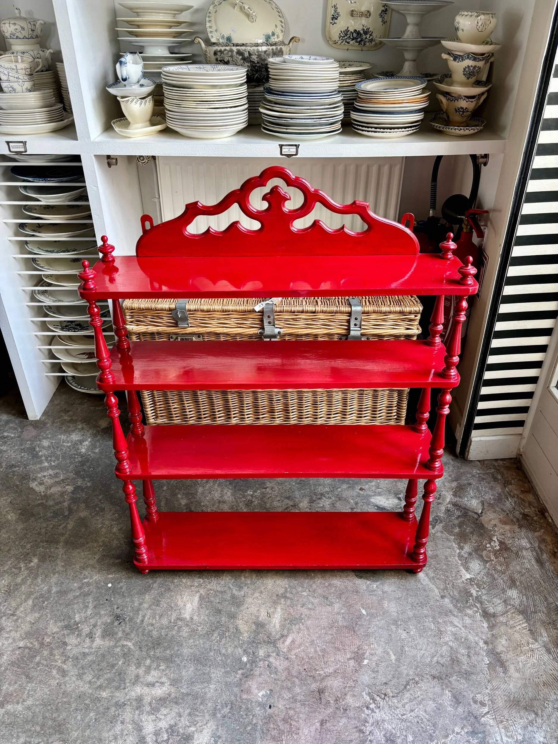 Wall shelf with 4 red lacquered wooden shelves.