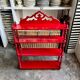 Wall shelf with 4 red lacquered wooden shelves.