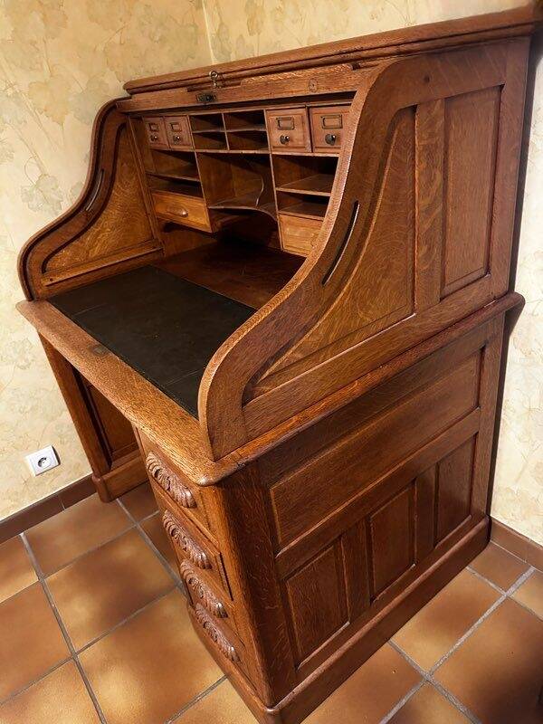Oak desk with sliding door and leather wood chair.