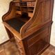 Oak desk with sliding door and leather wood chair.