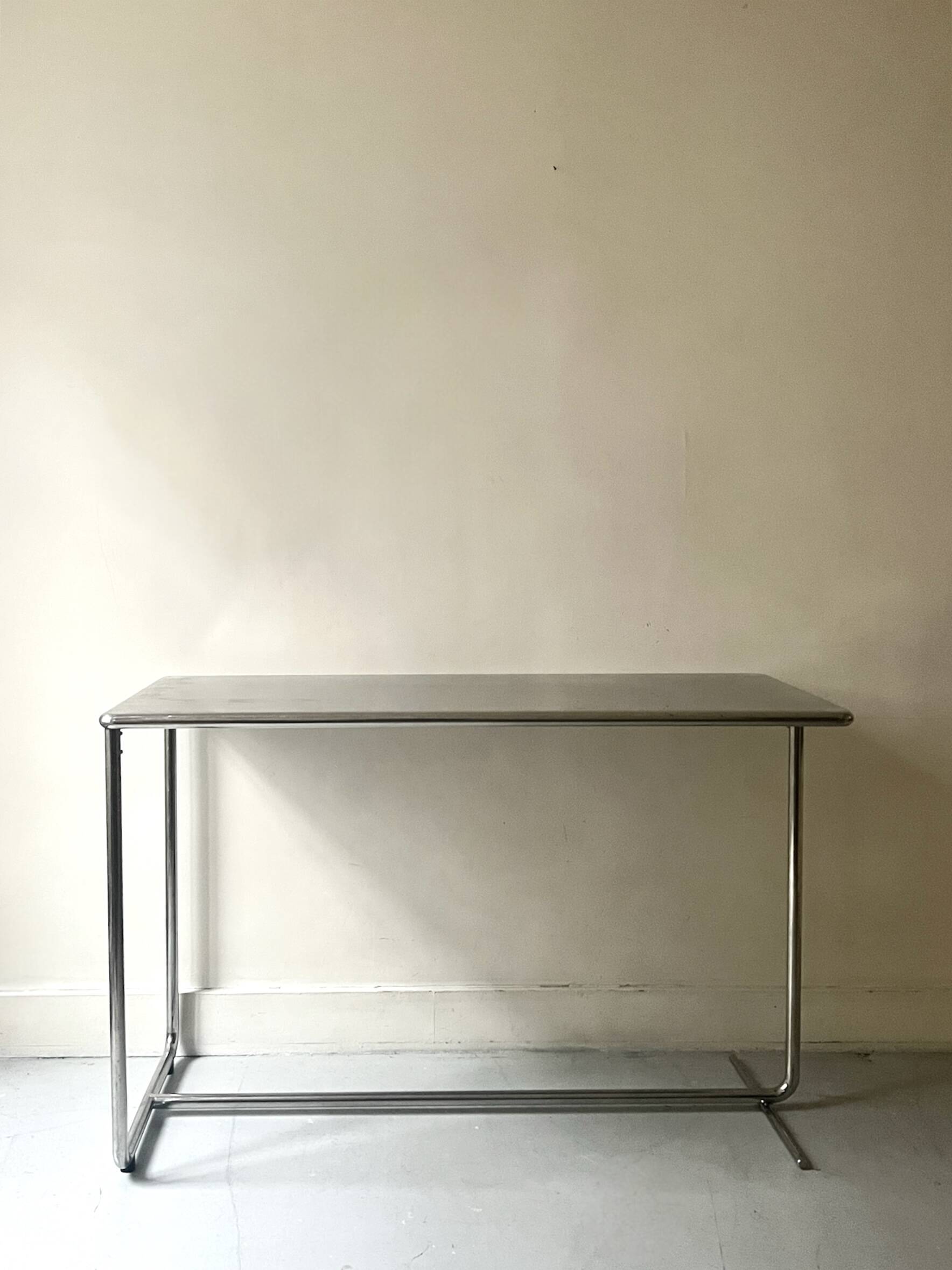 Dining table / tubular and modernist desk in chrome metal