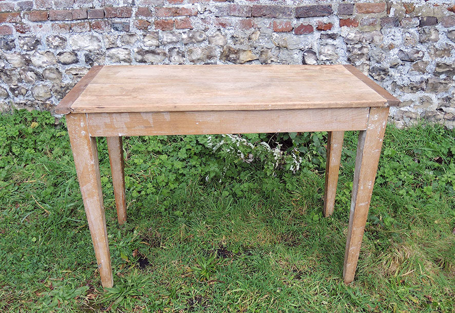 Old wooden farmhouse table with drawer