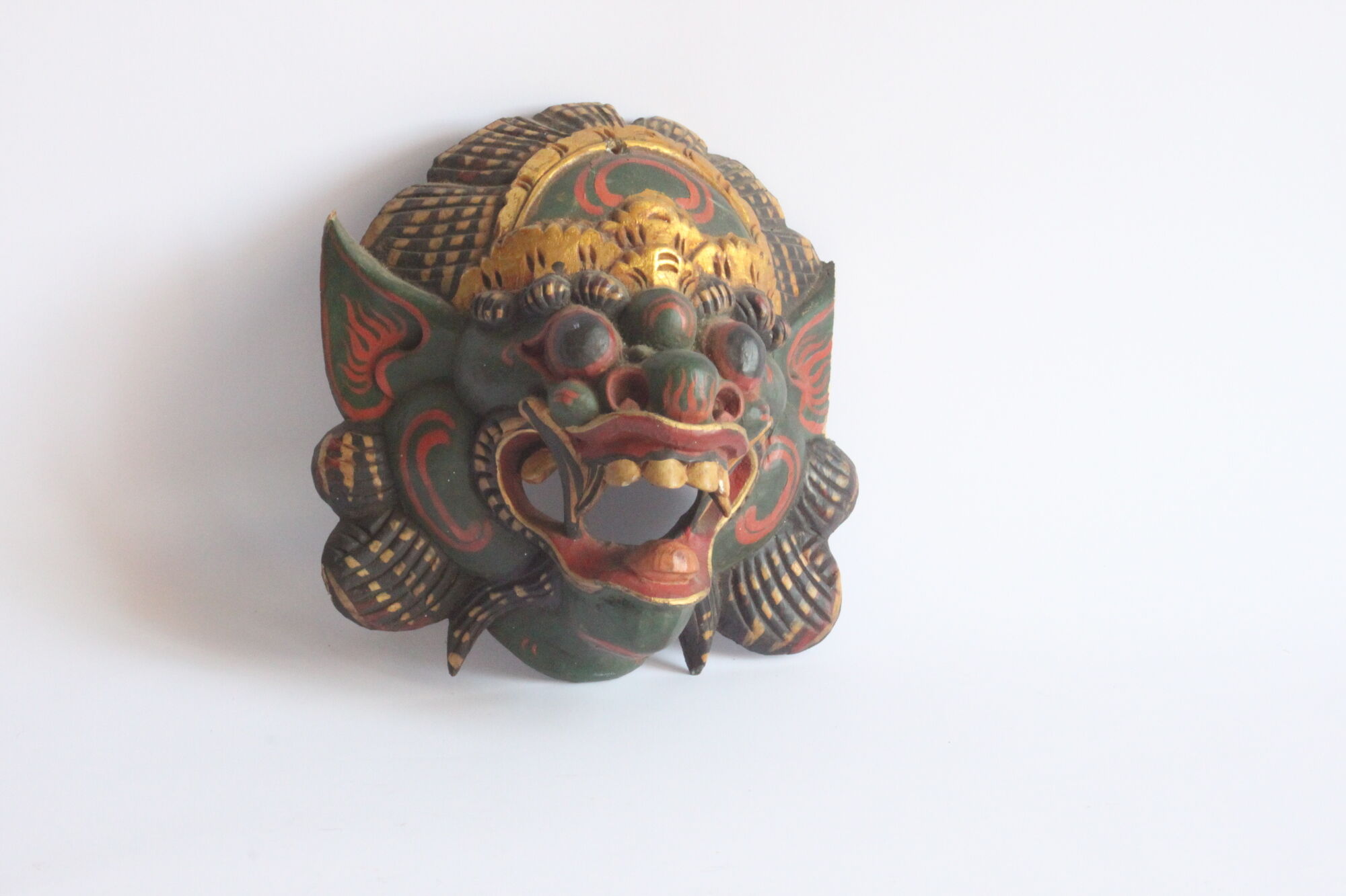 Two polychrome painted and gold leaf gilded Barong dance masks from Bali, Indonesia.
