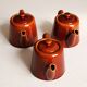 3 brown glazed ceramic teapots