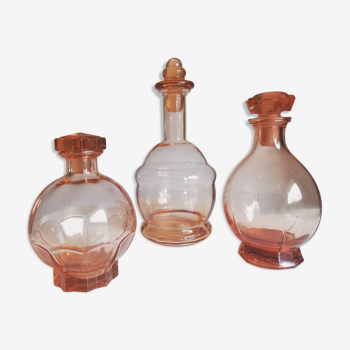 Trio of pink glass decanters