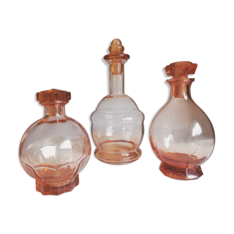 Trio of pink glass decanters
