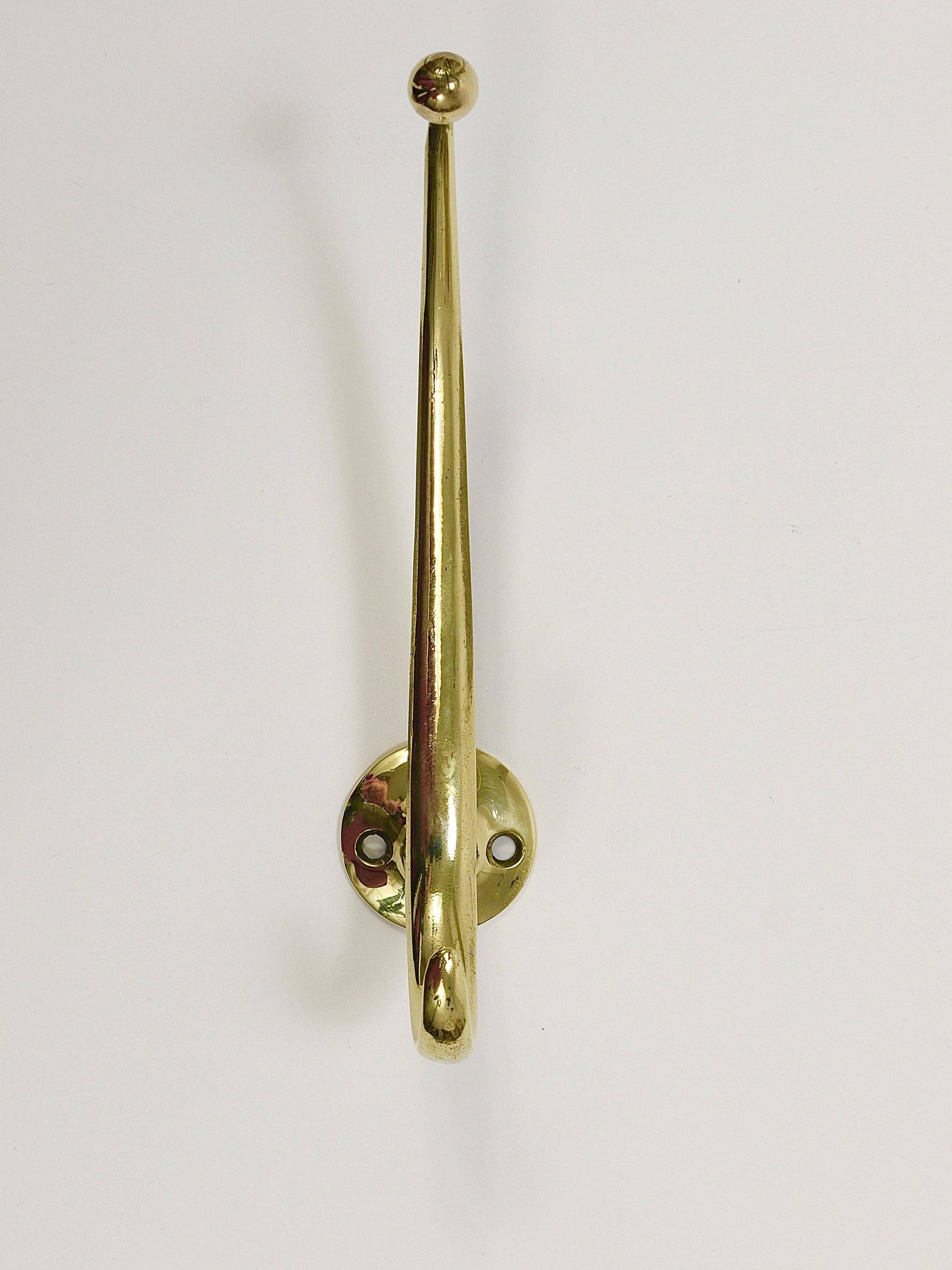 Two curved wall coat racks in brass by Franz Hagenauer, Vienna, mid-20th century, 1950s.