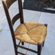 4 mismatched wood and straw chairs