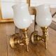 Set of 2 golden, bronze and brass torch wall lights