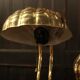 Pair of articulated brass lamps in the shape of a shell.