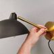 A wall lamp in black and brass-coloured finishes. Danish, early 2000s.