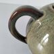 Vintage ceramic teapot with a flame design.