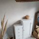 Old white asymmetrical chest of drawers
