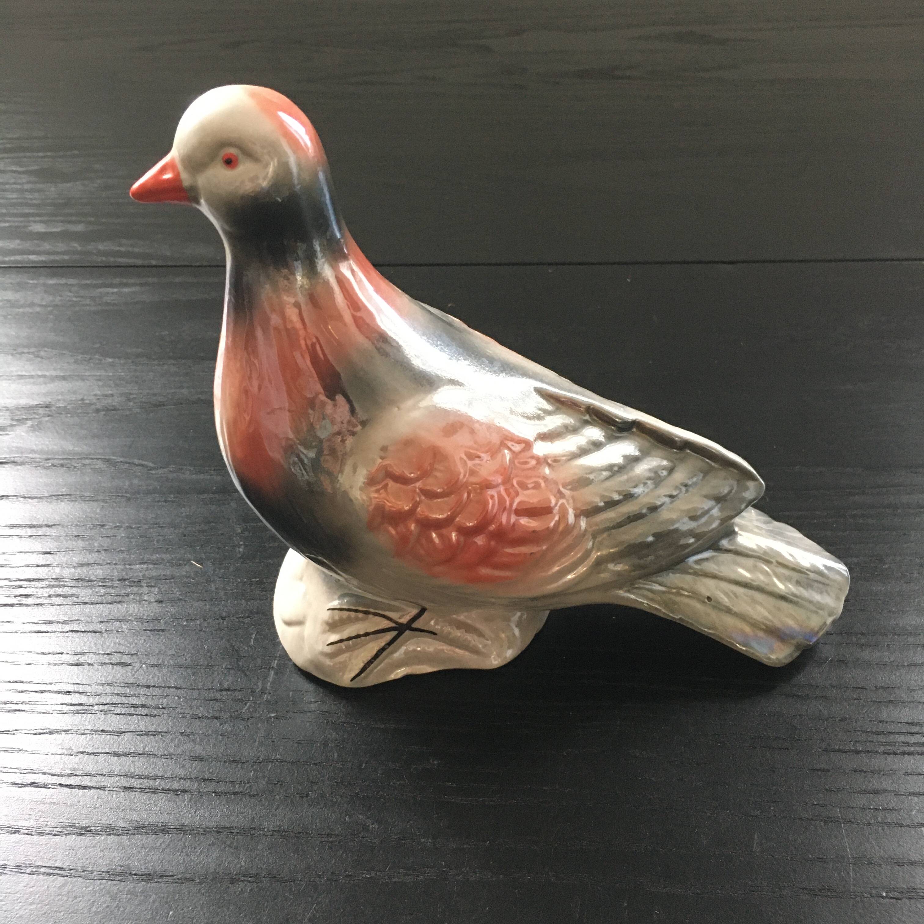 Antique bird in pearly ceramic