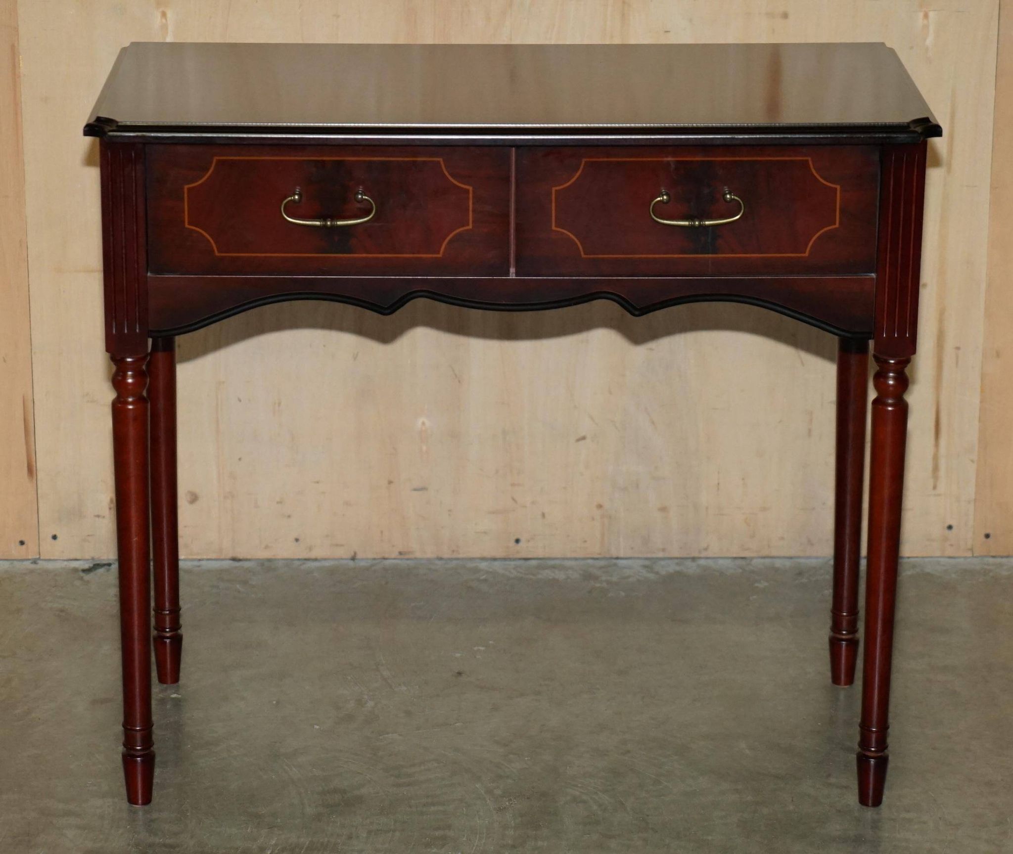 Small console with two drawers in hardwood finish.
