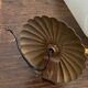 Gold metal wall light with ribbed glass.