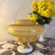 Art Nouveau table lamp with a yellow floral globe.