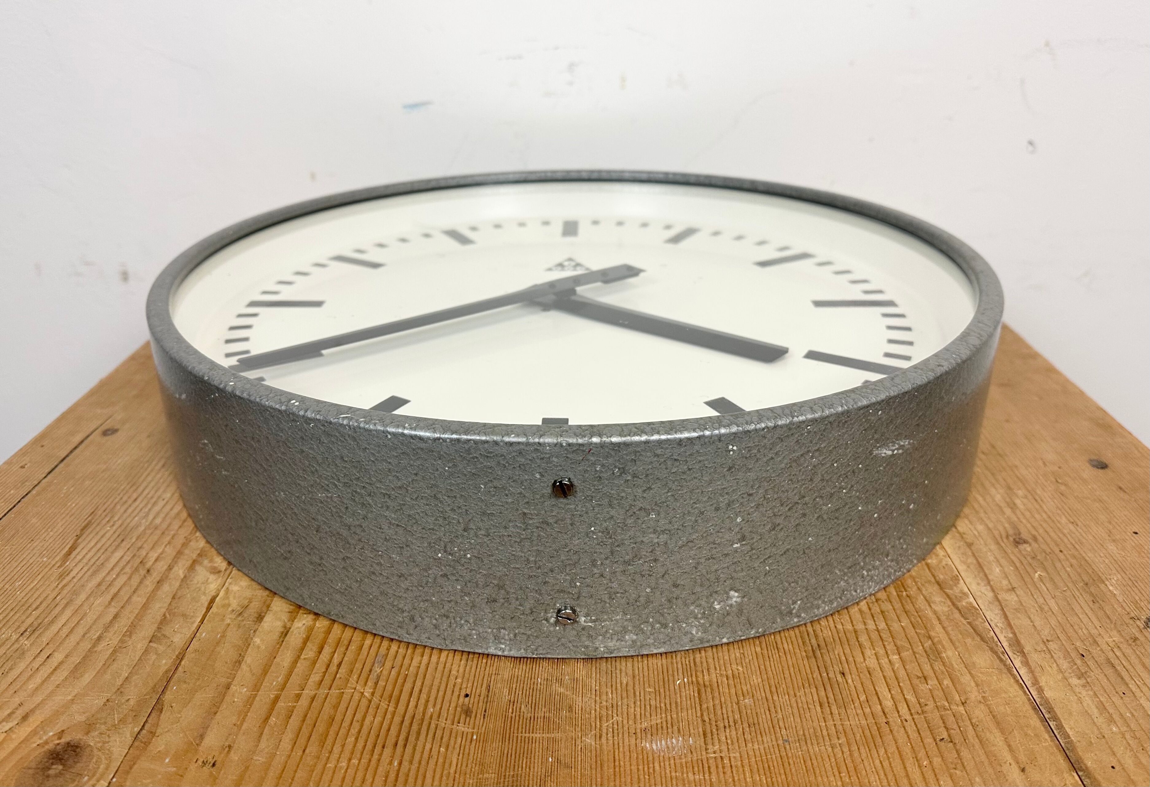 Grey industrial factory wall clock from pragotron, 1960s