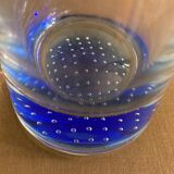 Glass roller vase with blue bubble background