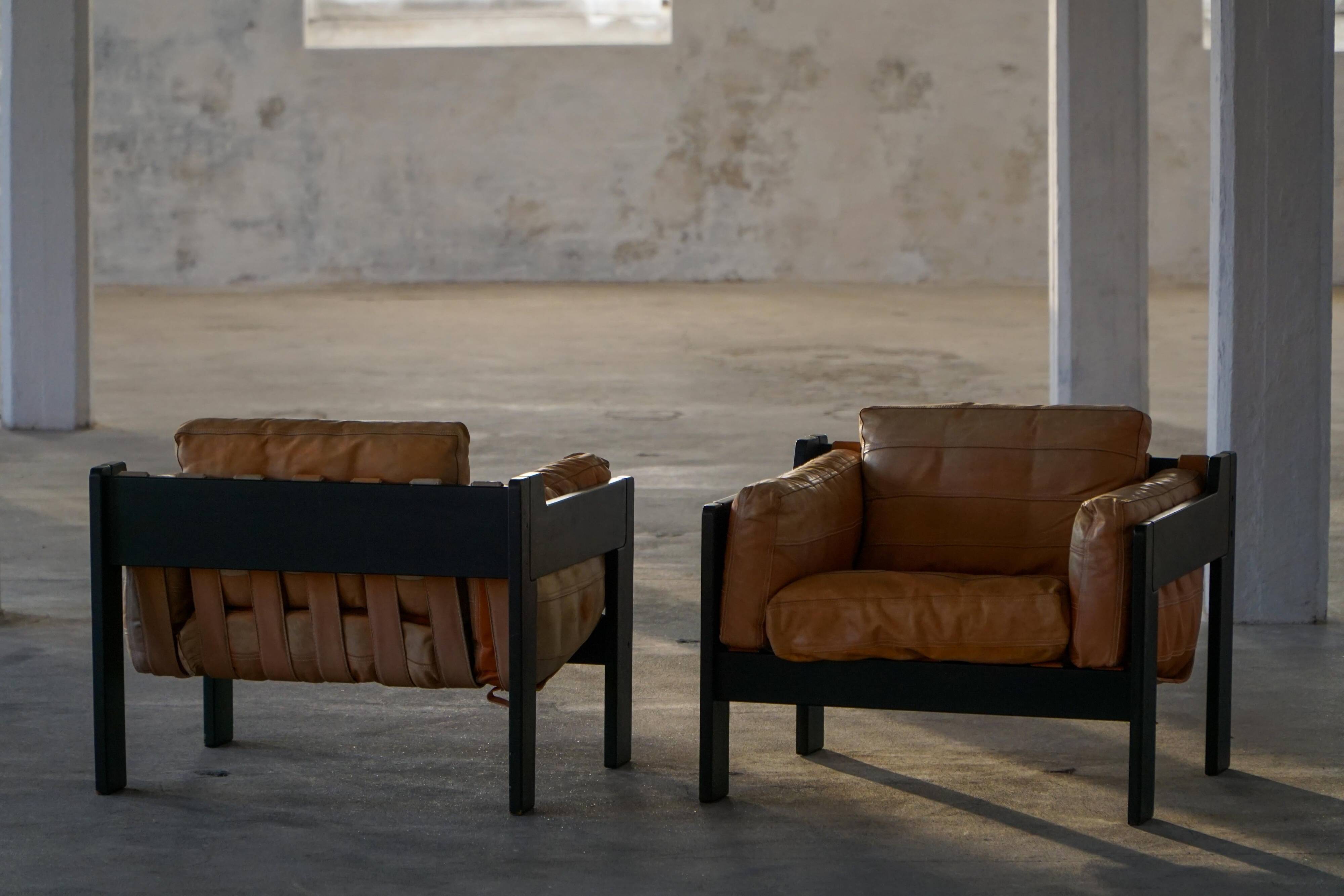 Pair of wooden and leather armchairs by Rud Thygesen & Johnny Sørensen, 1970s.