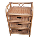 Small storage unit / freestanding shelf in light rattan.