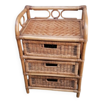 Small storage unit / freestanding shelf in light rattan.