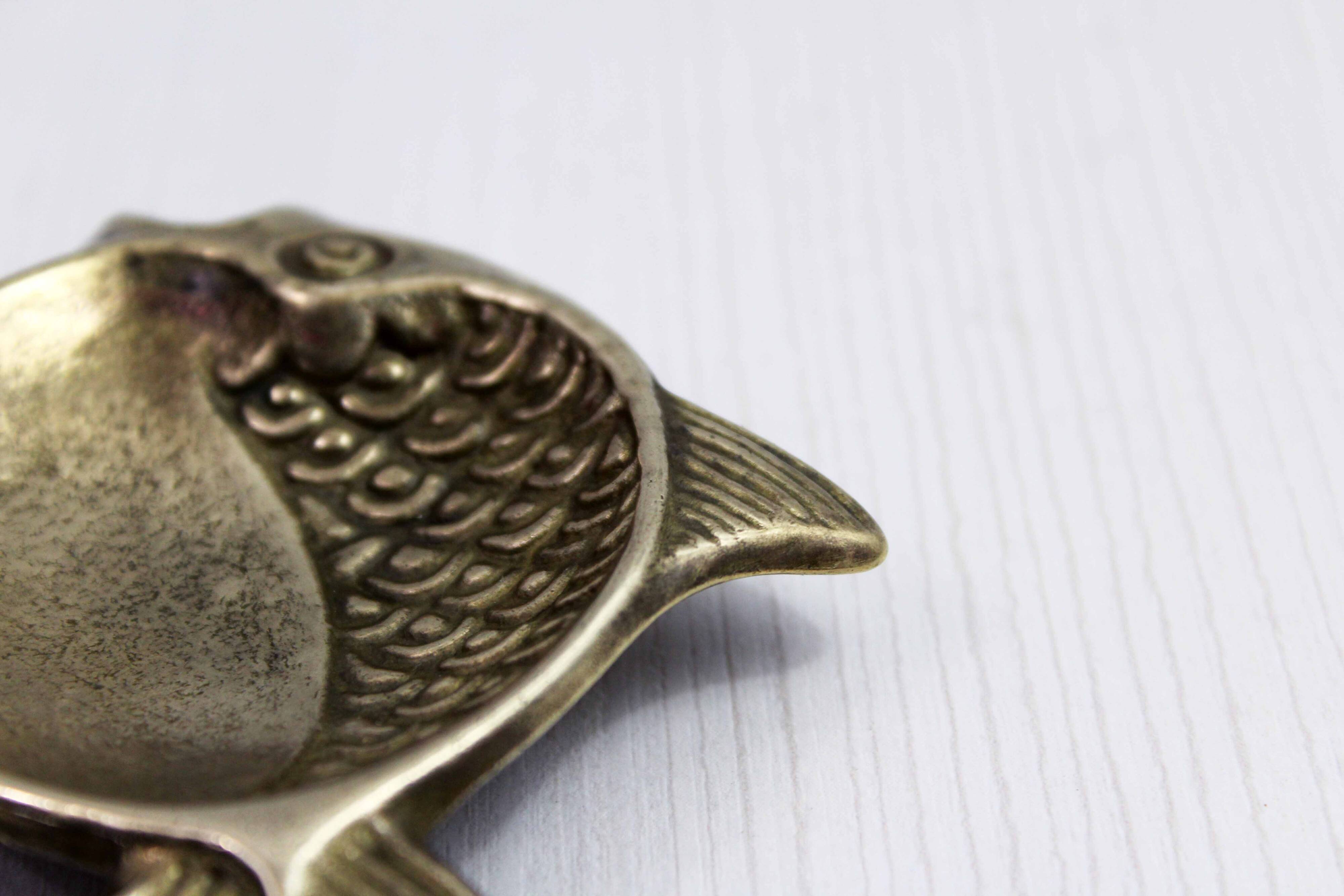 Vintage fish-shaped brass pocket emptier