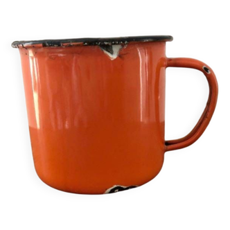 Damaged orange enameled metal mug