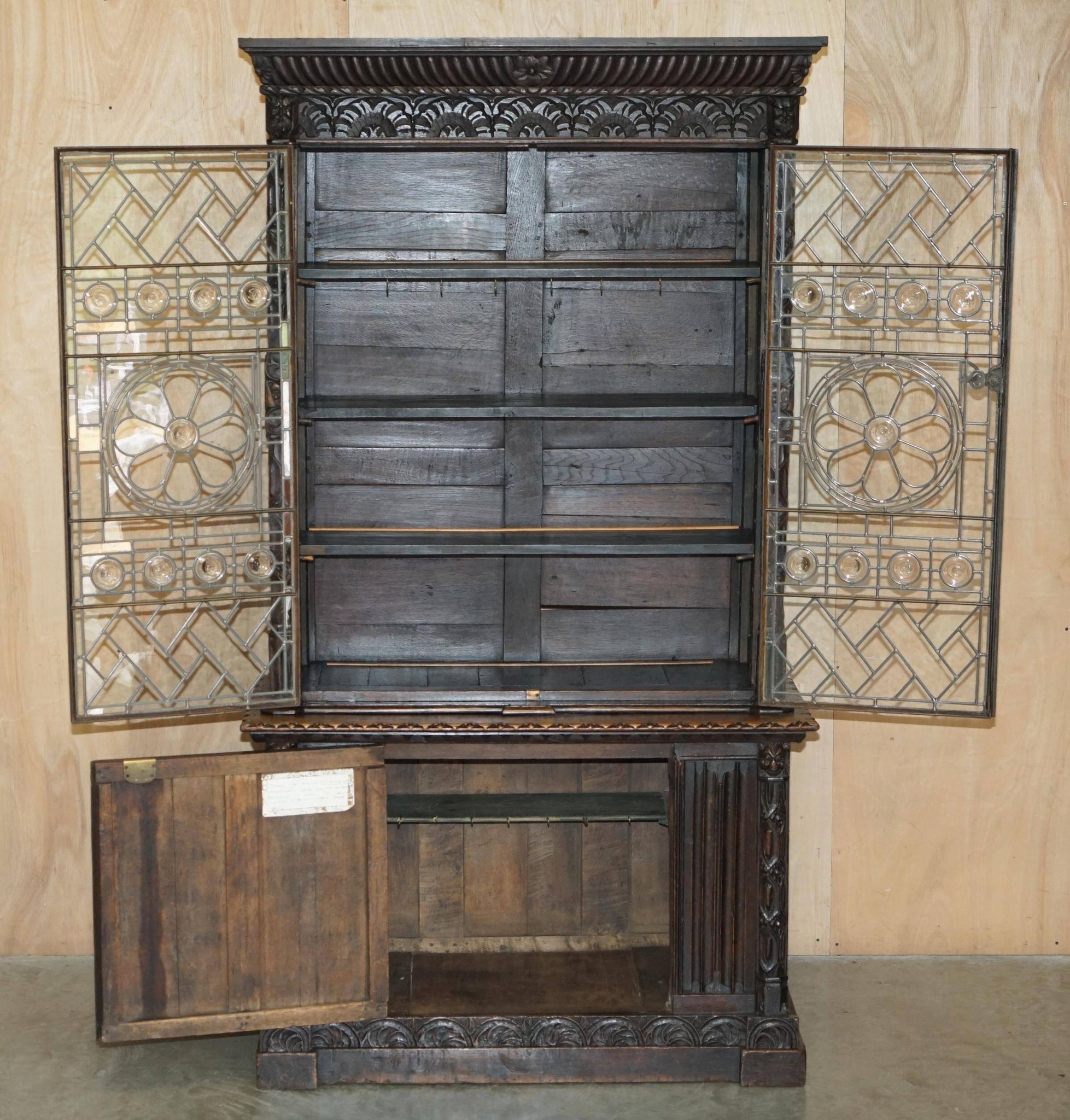 Jacobean hardwood library with carved panels and glass doors.