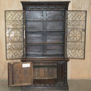 Jacobean hardwood library with carved panels and glass doors.