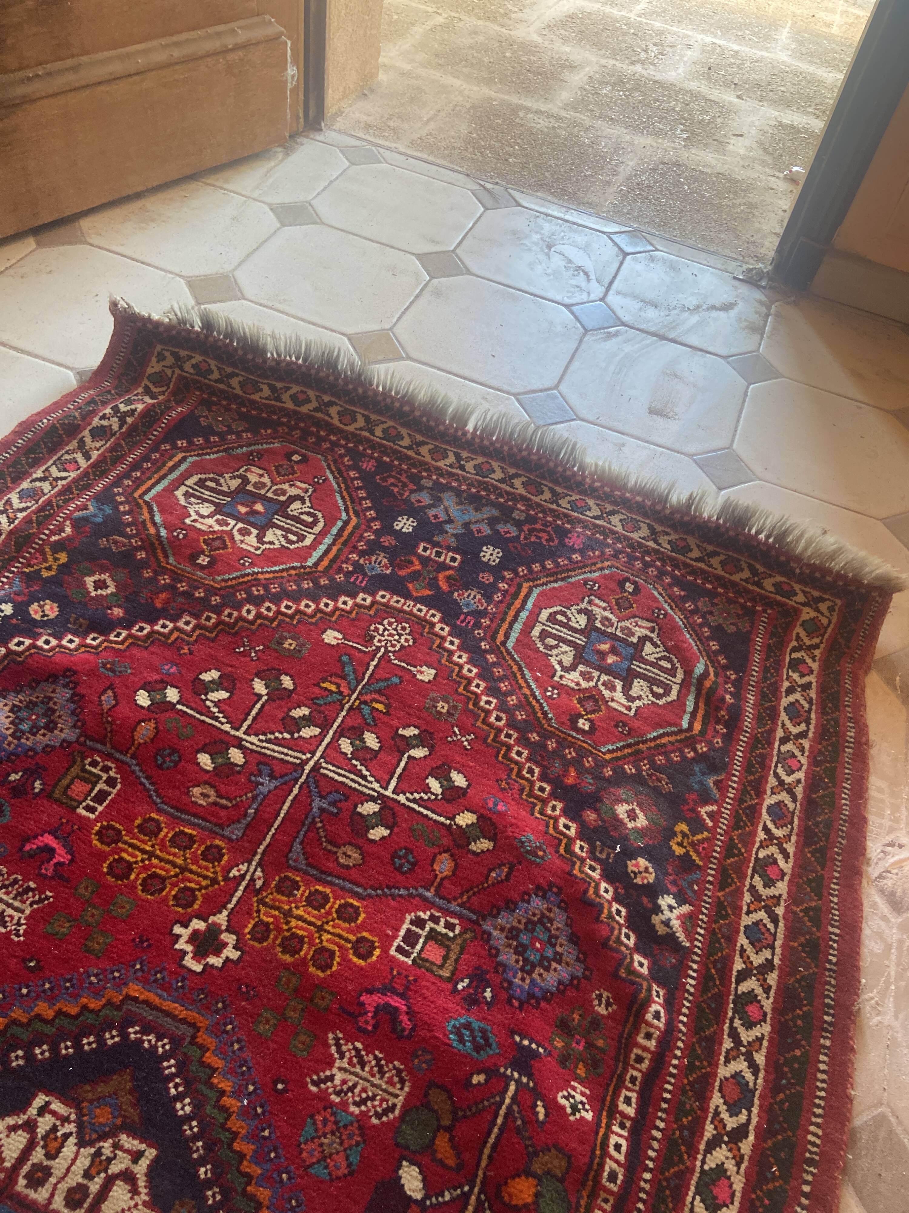 Large antique Oriental hallway carpet made of hand-knotted wool.