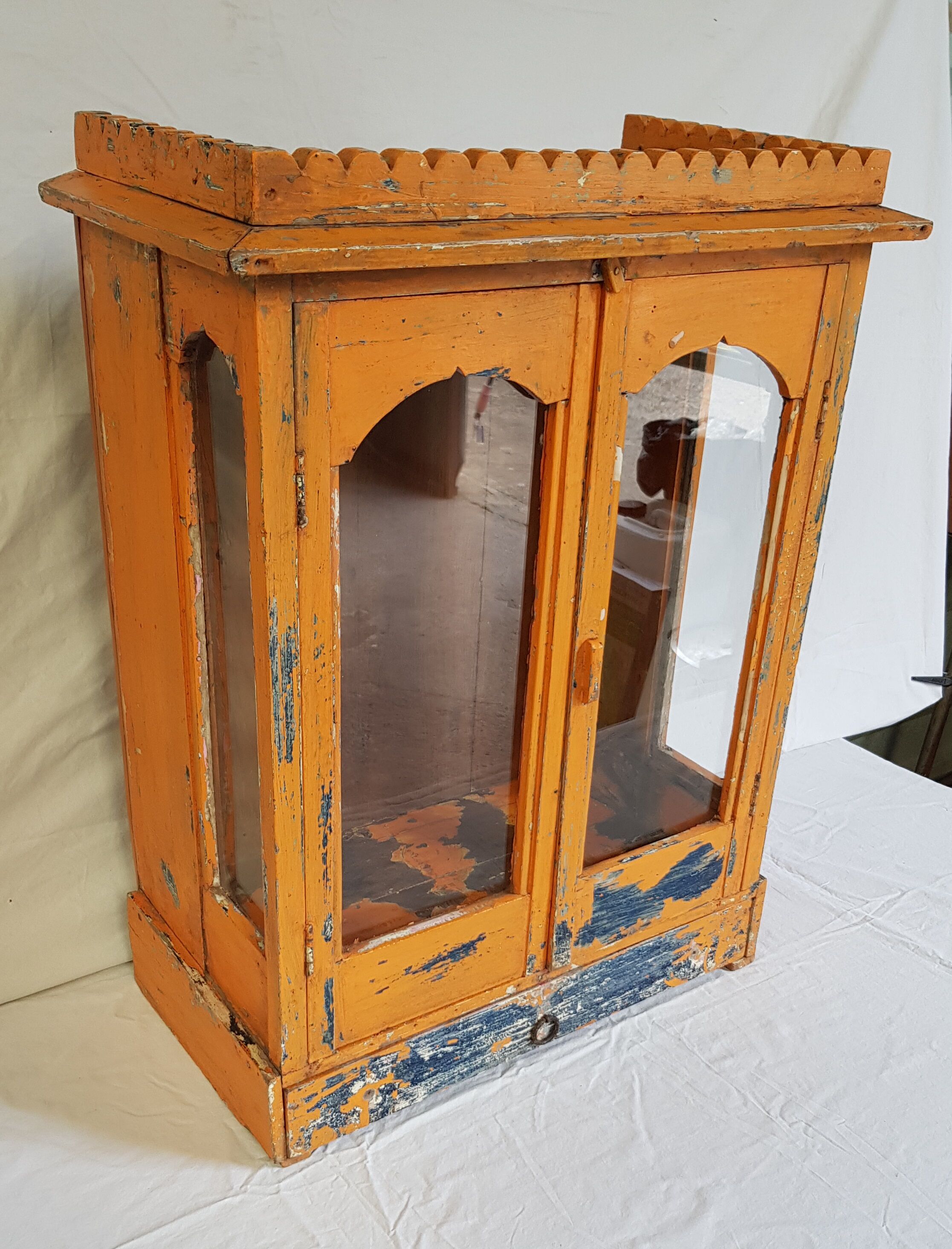 Old temple-showcase with teak offerings