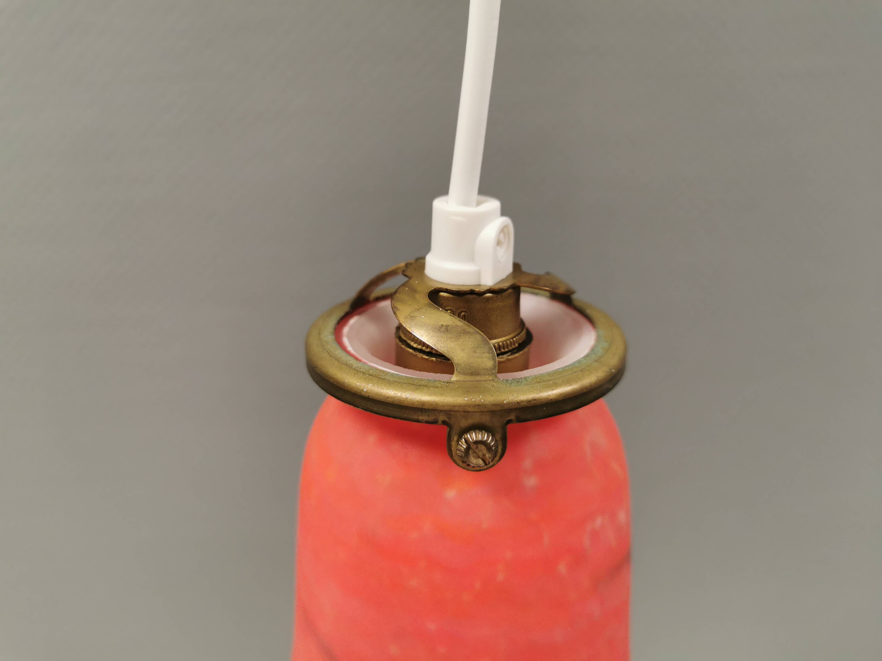 Small, beautiful hanging lamp in Art Deco style with brass top.