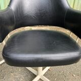 Pair of vintage armchairs in black skai with metal legs.