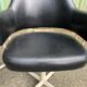Pair of vintage armchairs in black skai with metal legs.