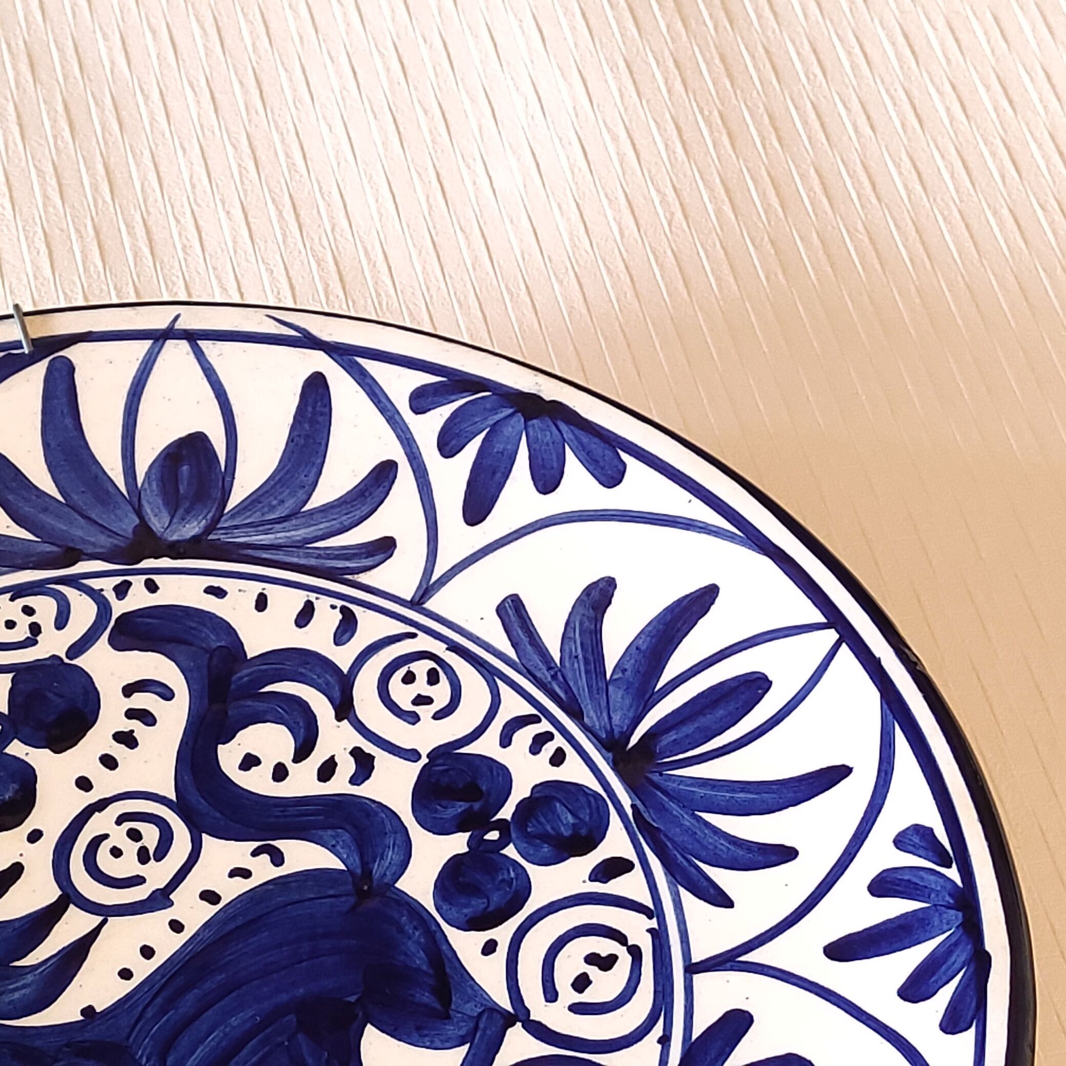 Hand-painted decorative plate decorated with a blue chimera pattern