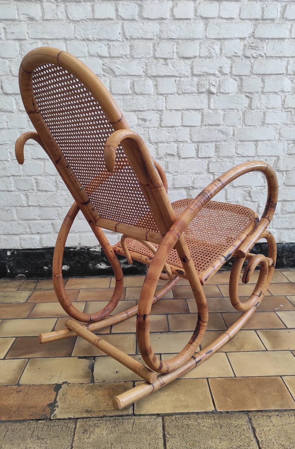 Vintage rocking chair in rattan and cane.