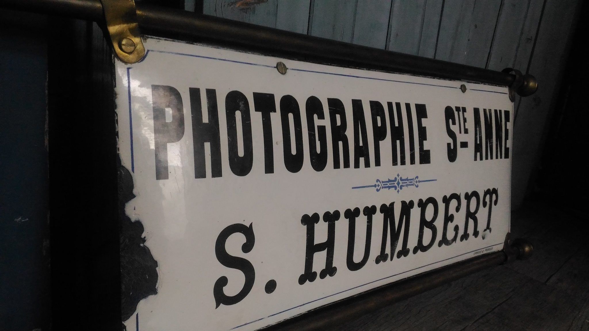 Photographer enamel sign