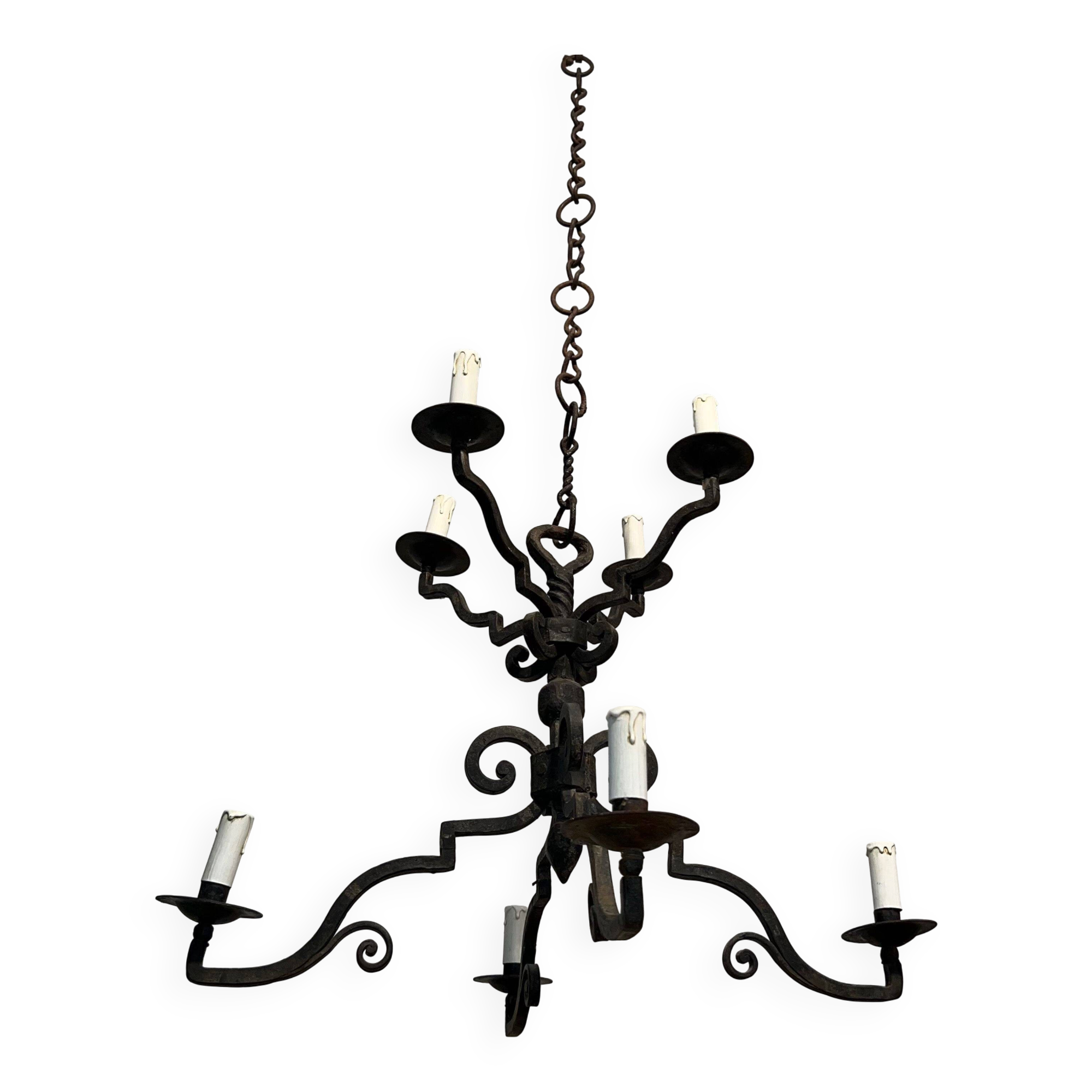 Two-tiered wrought iron chandelier with eight light arms in Gothic style.