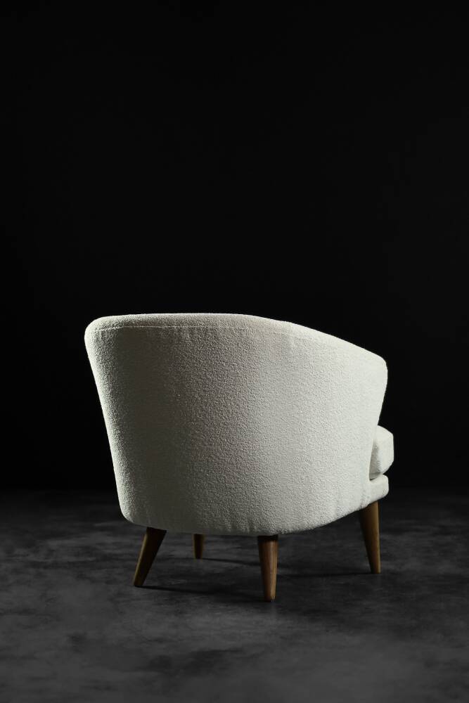 Low oak armchair with modern mid-century Scandinavian fabric and rounded backrest, 1960s.