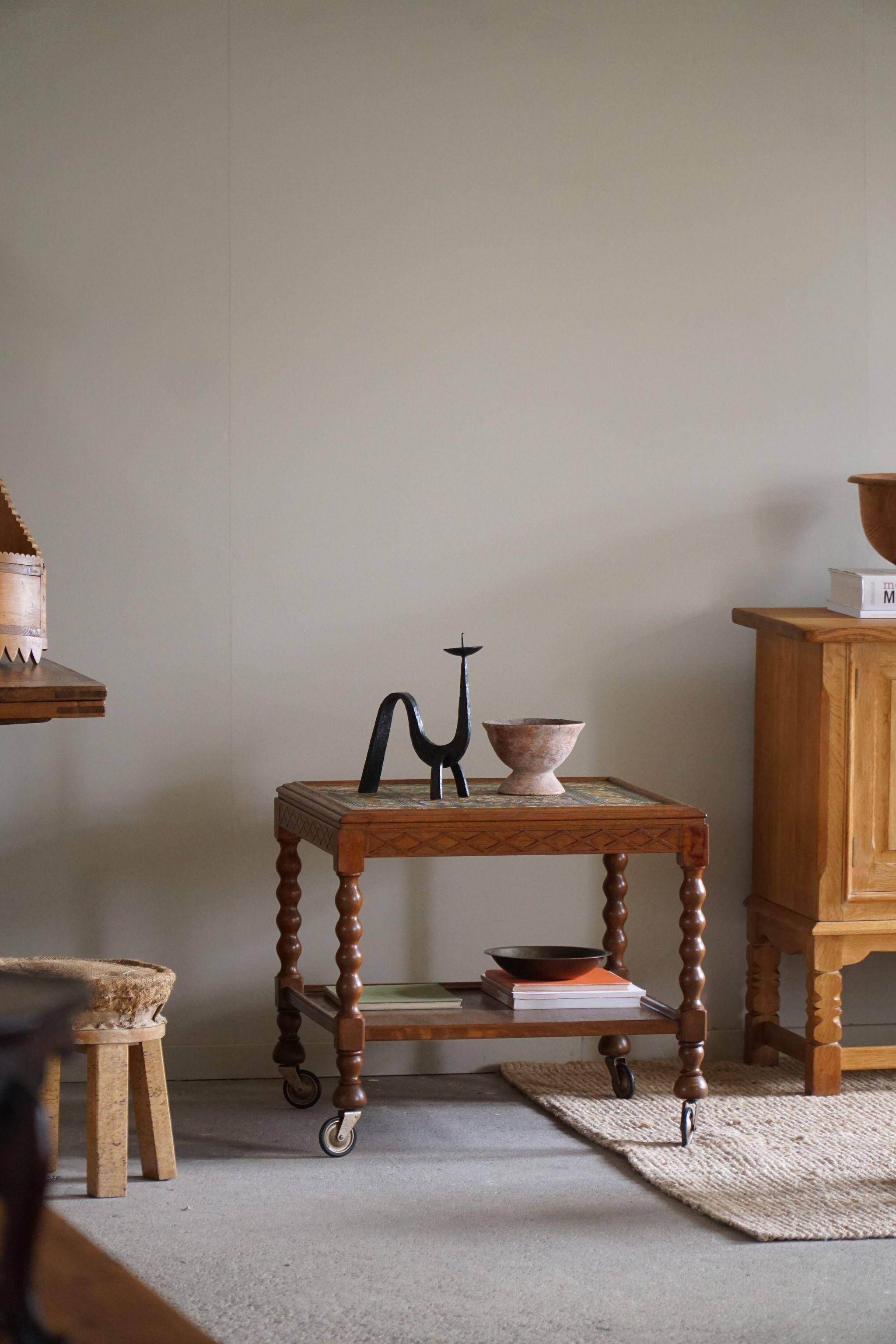 Modern Danish service table with turned spool legs and coloured tiles, 1950s.