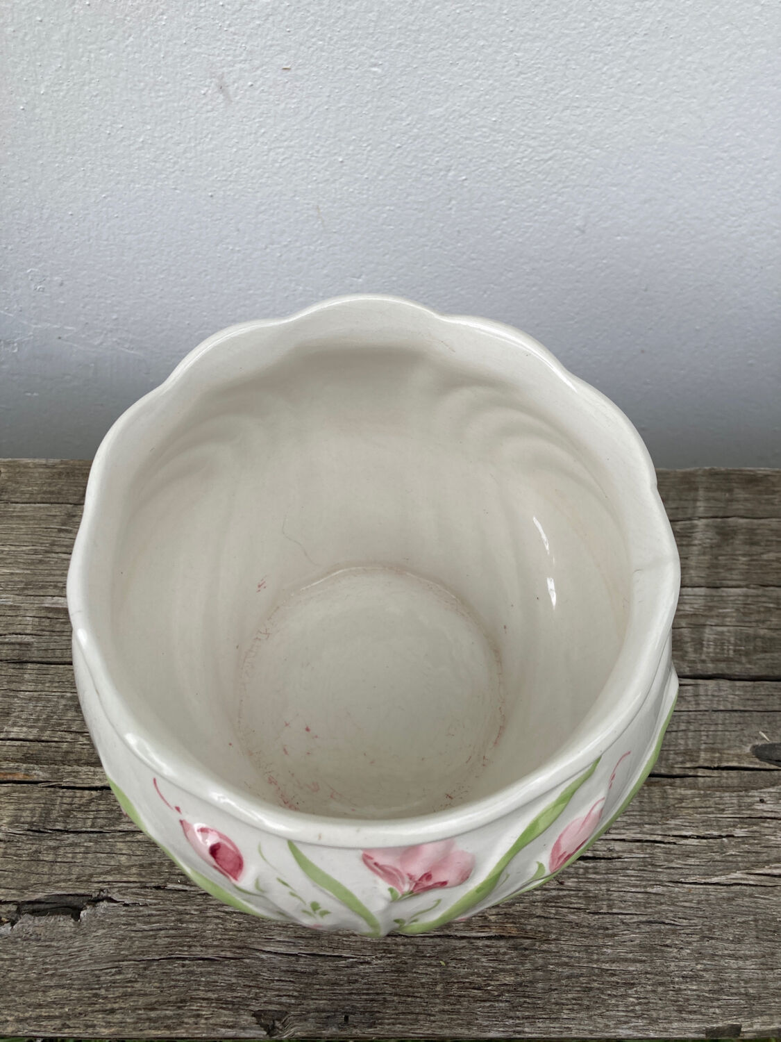 White ceramic pot cache in old flower slip